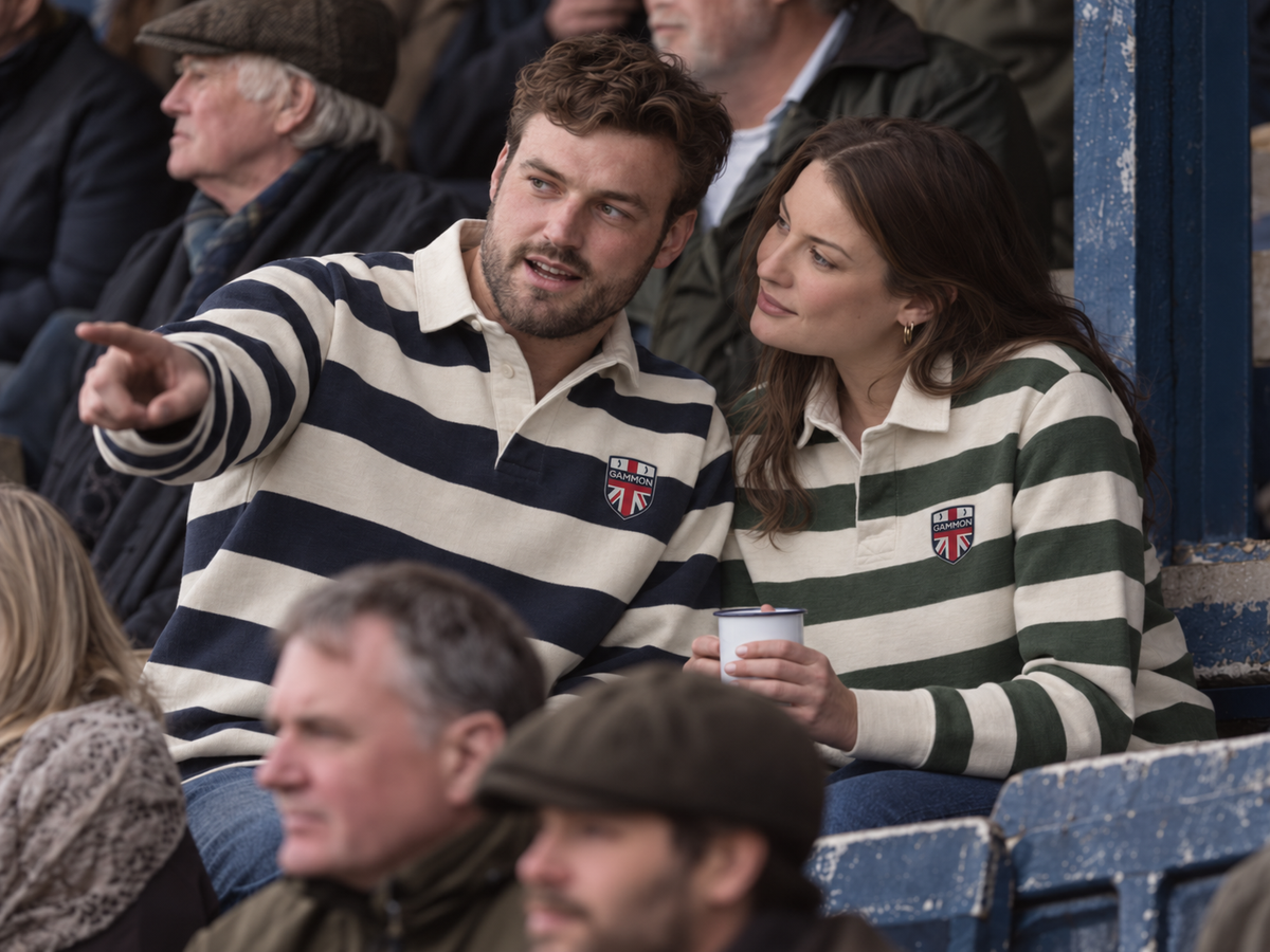 Man and woman wearing navy and ecru and utility green and ecru striped Whitby Sporting Shirts in a traditional sports stand