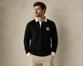 Male model wearing the black Gammon Stamford Sporting Shirt with white collar and button cuffs against a textured neutral studio backdrop