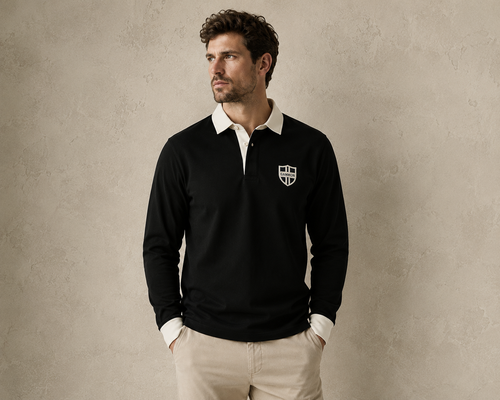 Male model wearing the black Gammon Stamford Sporting Shirt with white collar and button cuffs against a textured neutral studio backdrop