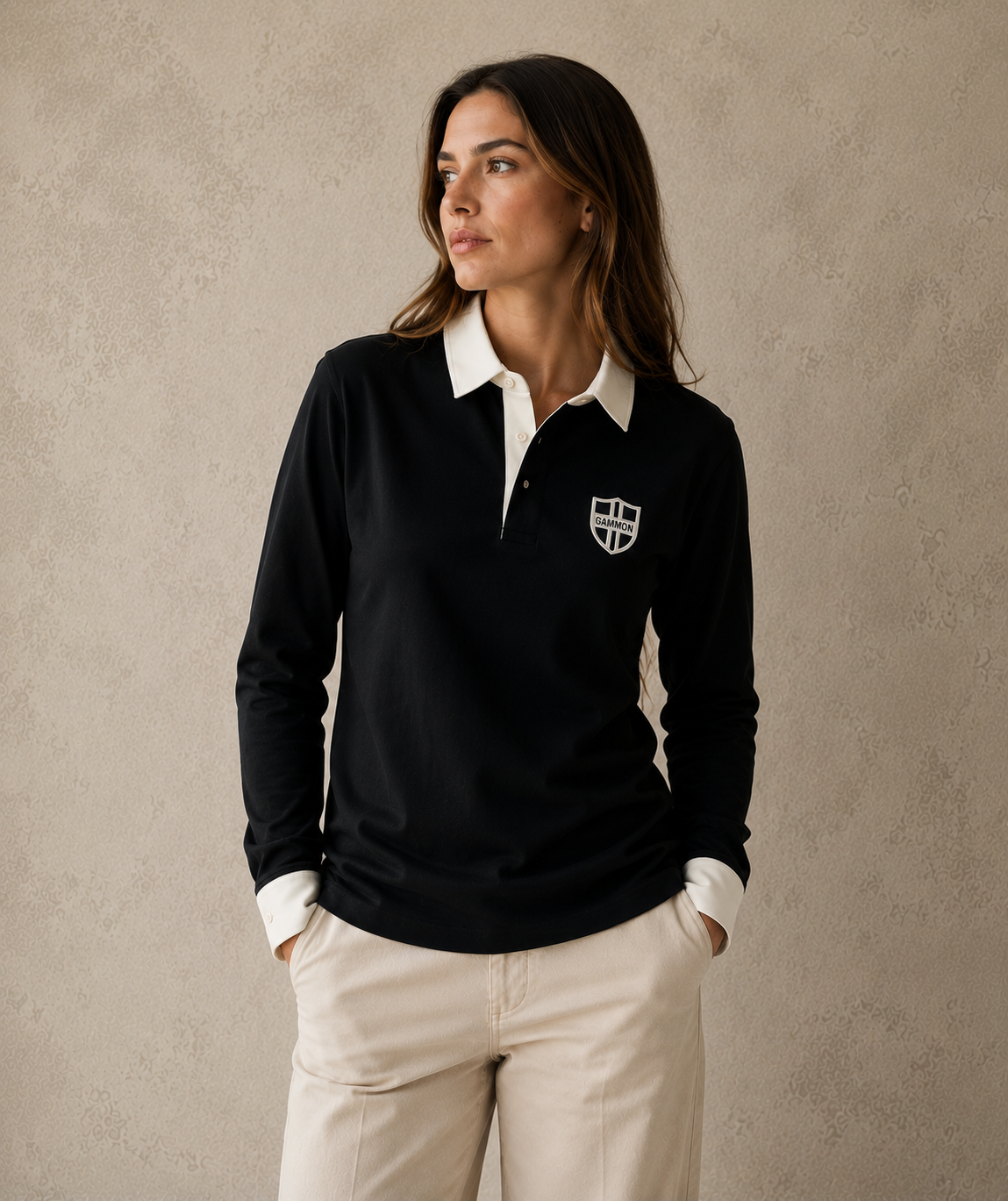 Woman wearing the black Gammon Stamford Sporting Shirt with structured white collar and button cuffs against a textured neutral studio backdrop
