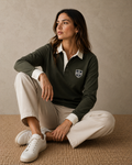 Woman wearing the utility green Gammon Stamford Sporting Shirt with structured white collar and button cuffs in a relaxed studio portrait setting